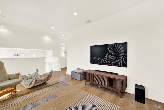 interior space featuring recessed lighting, visible vents, baseboards, and hardwood / wood-style flooring