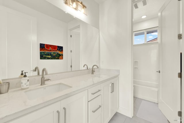 full bath featuring tile patterned flooring, double vanity, visible vents, and a sink