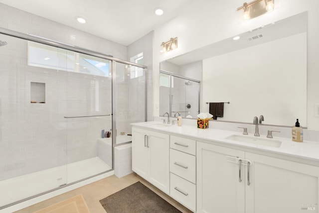 full bathroom with a sink, visible vents, double vanity, and a shower stall