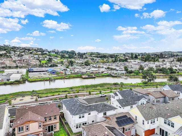 drone / aerial view featuring a residential view and a water view