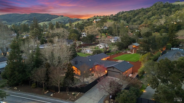 drone / aerial view featuring a mountain view and a wooded view