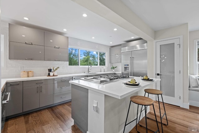 550 Sequoia Dr, San Anselmo, CA 94960 - kitchen with tasteful backsplash, a breakfast bar, gray cabinets, appliances with stainless steel finishes, and a sink