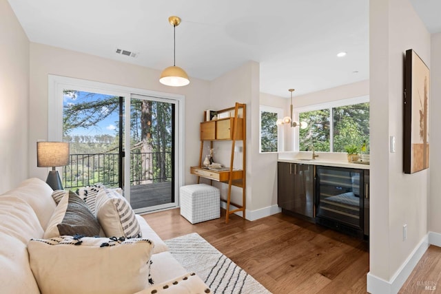 550 Sequoia Dr, San Anselmo, CA 94960 - living room with visible vents, beverage cooler, baseboards, and wood finished floors