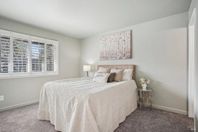 bedroom with carpet floors and baseboards