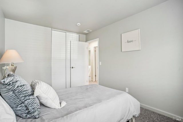 bedroom with baseboards, visible vents, and carpet flooring