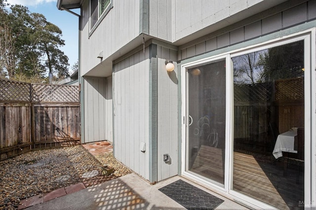 entrance to property featuring fence