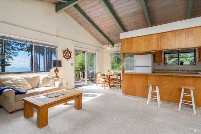 living room with high vaulted ceiling, beamed ceiling, wood ceiling, and light colored carpet