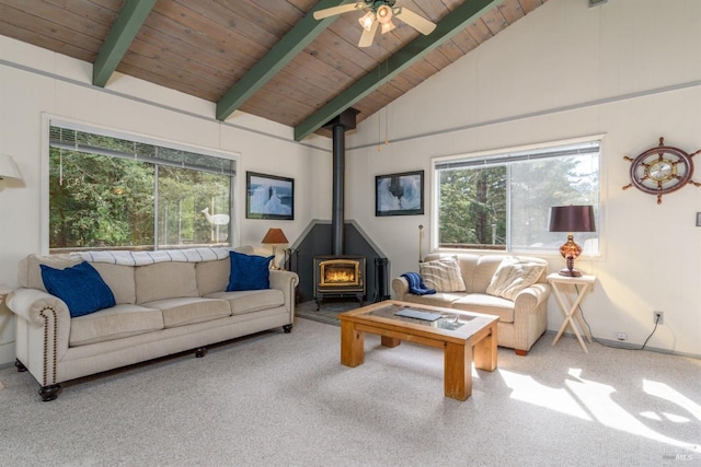 living room featuring a wood stove, wooden ceiling, ceiling fan, and beamed ceiling