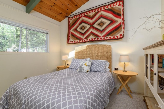 bedroom with vaulted ceiling, carpet, and wood ceiling