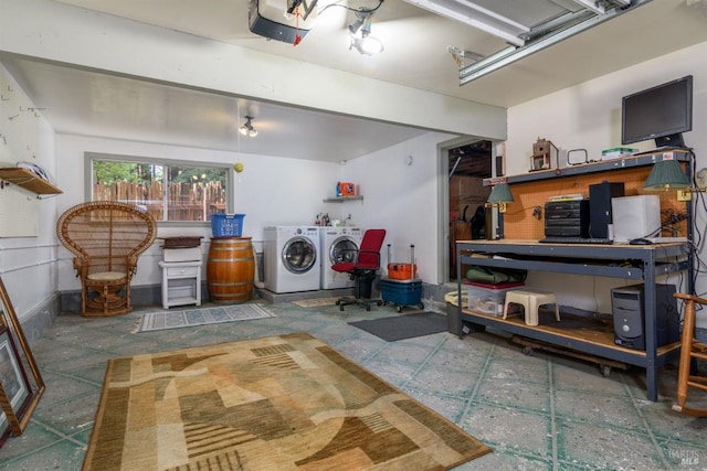 laundry area with a garage, laundry area, washing machine and clothes dryer, and a workshop area