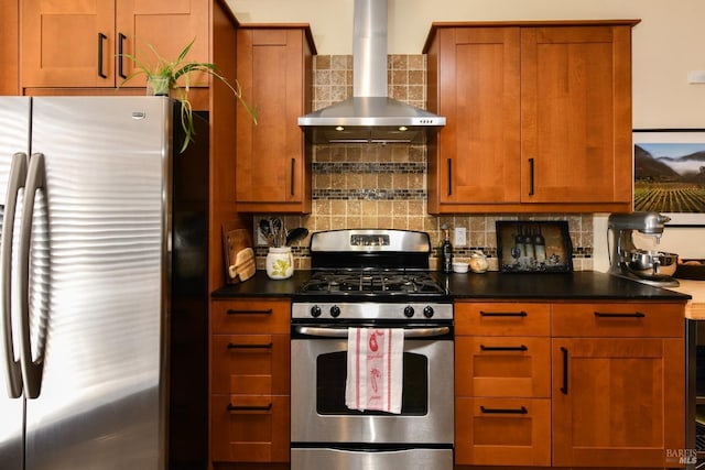 kitchen with brown cabinetry, dark countertops, wall chimney exhaust hood, stainless steel appliances, and backsplash