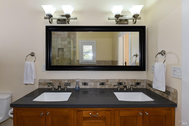 full bath featuring double vanity, a sink, and toilet