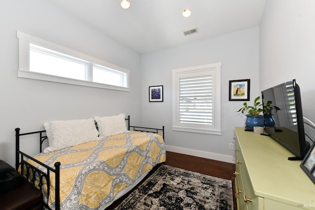 bedroom featuring dark wood-style flooring, visible vents, and baseboards