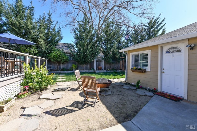 view of patio featuring fence and a fire pit