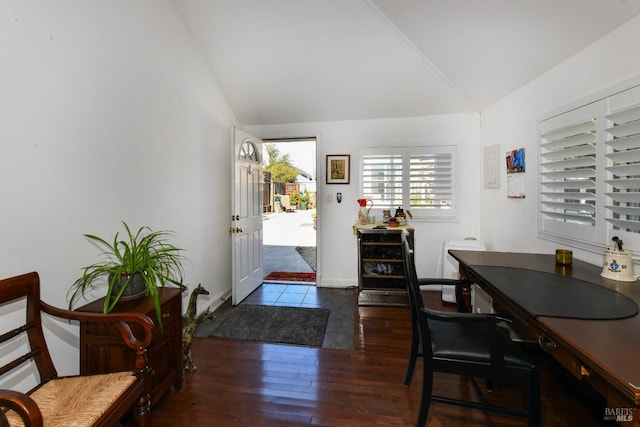 foyer entrance with hardwood / wood-style flooring and vaulted ceiling