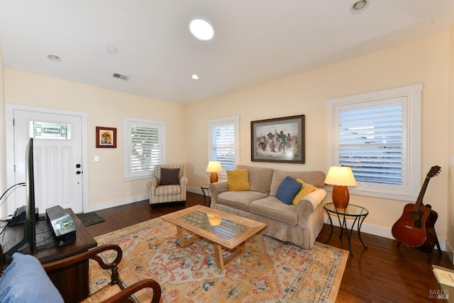 living room with recessed lighting, wood finished floors, visible vents, and baseboards