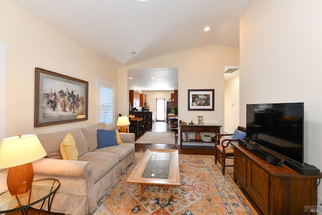 living room with light wood-type flooring, visible vents, vaulted ceiling, and recessed lighting