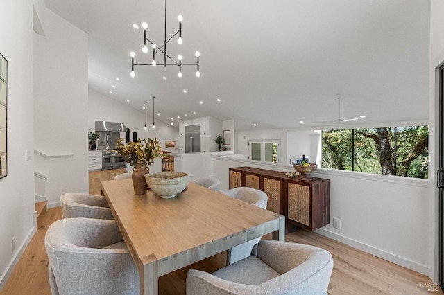 dining room with lofted ceiling, baseboards, light wood-style flooring, and recessed lighting