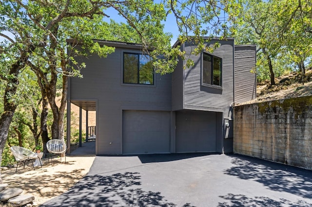 modern home with a garage and aphalt driveway