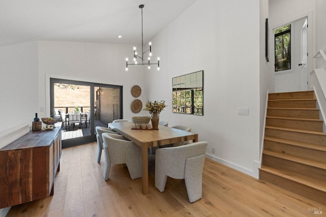 dining area with light wood-type flooring, stairs, and a wealth of natural light