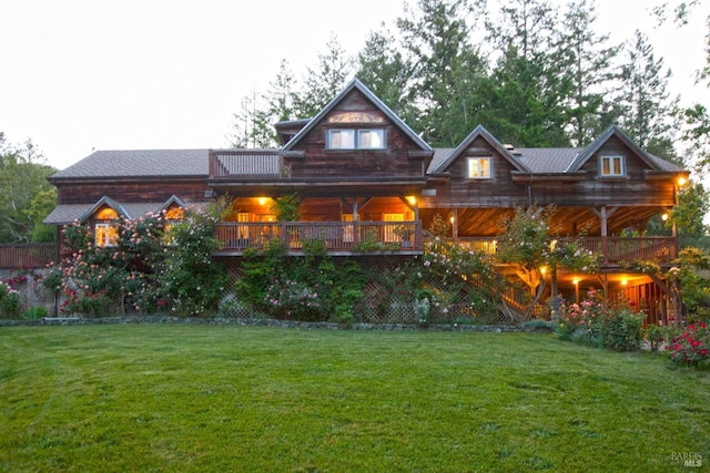 rear view of house featuring a lawn