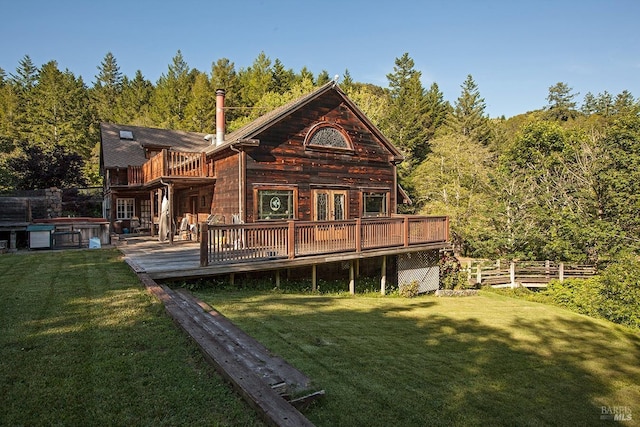 back of house with a yard, a wooden deck, and a hot tub