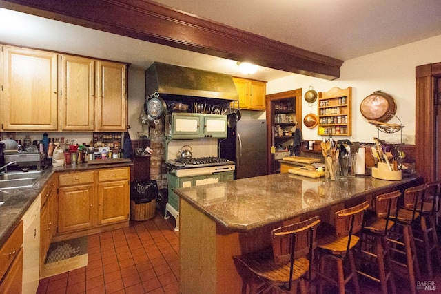 kitchen with dishwasher, dark tile patterned flooring, a breakfast bar, a peninsula, and exhaust hood