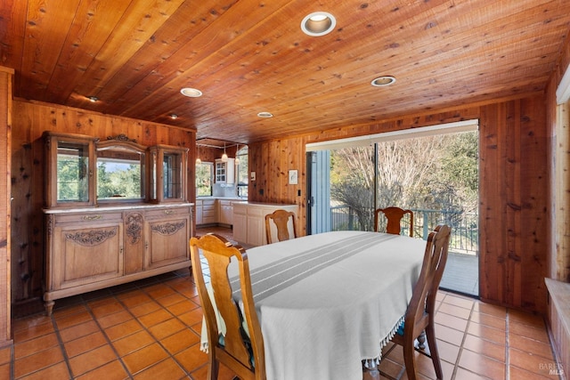 dining room with light tile patterned floors, recessed lighting, wood ceiling, and wood walls