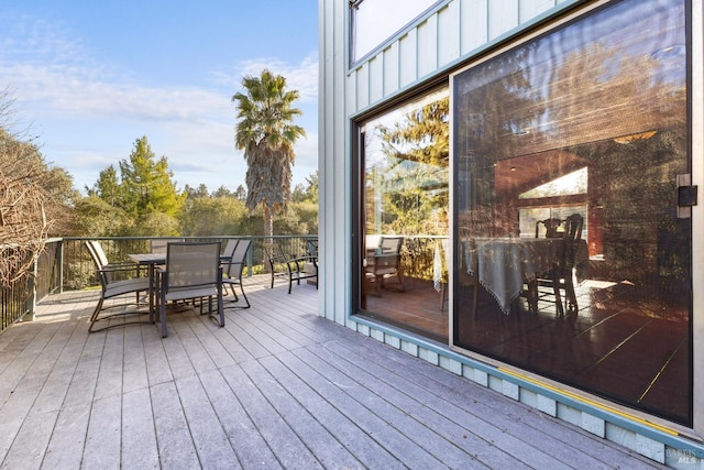 wooden deck featuring outdoor dining space