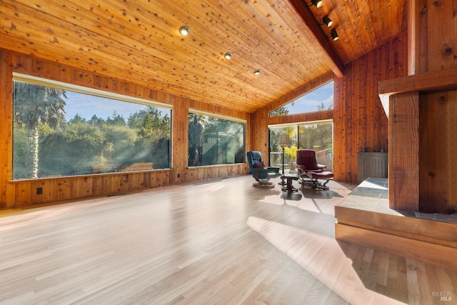 sunroom / solarium featuring vaulted ceiling with beams and wooden ceiling