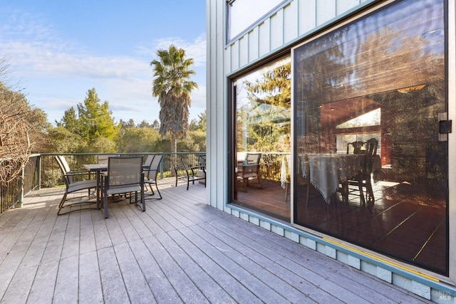 wooden terrace featuring outdoor dining space