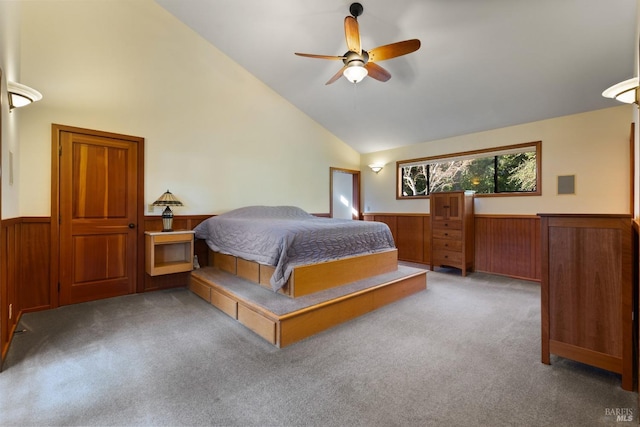 carpeted bedroom with a wainscoted wall, high vaulted ceiling, and wooden walls