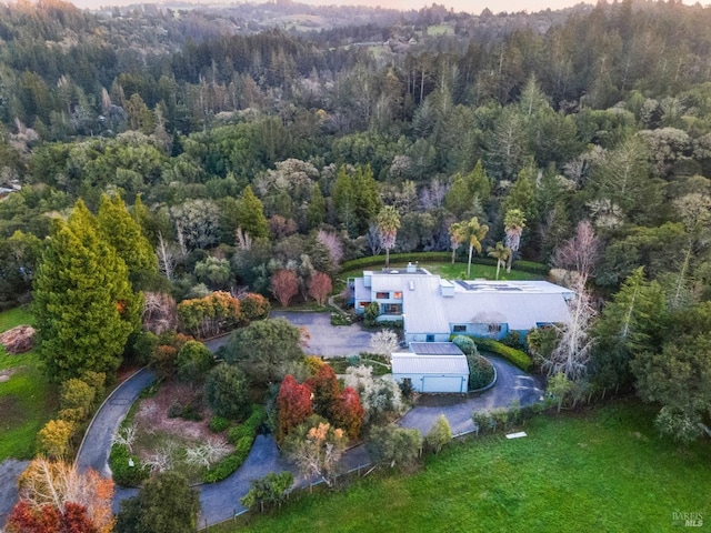 birds eye view of property with a forest view