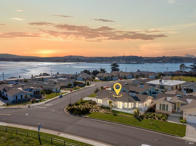 birds eye view of property with a residential view and a water view