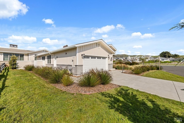 view of home's exterior featuring concrete driveway, a lawn, and a garage