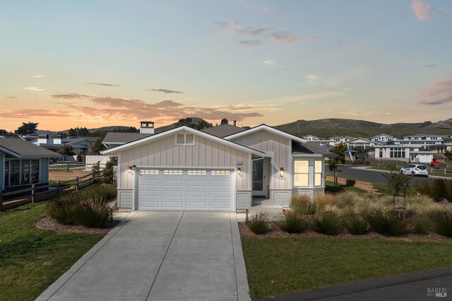 view of front of property featuring an attached garage, board and batten siding, and concrete driveway