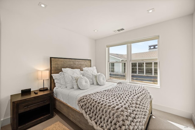 carpeted bedroom featuring recessed lighting, visible vents, and baseboards