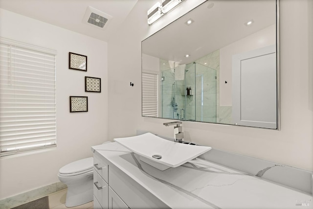 full bath with a marble finish shower, visible vents, toilet, recessed lighting, and vanity