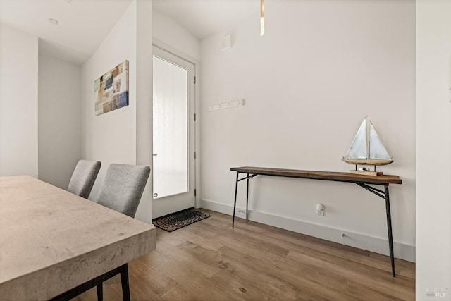 dining area featuring wood finished floors and baseboards