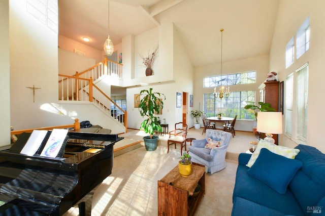 carpeted living room with stairs, high vaulted ceiling, and a notable chandelier