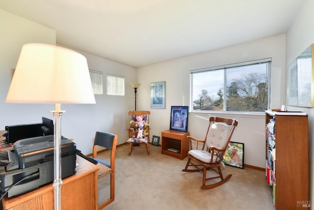 carpeted home office featuring baseboards