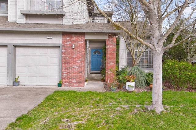 entrance to property featuring a garage, concrete driveway, brick siding, and a shingled roof