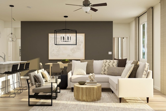 living room with a ceiling fan, light wood-type flooring, and baseboards