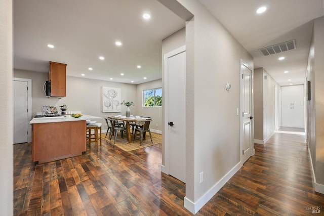 kitchen with dark wood-style floors, visible vents, black microwave, and recessed lighting