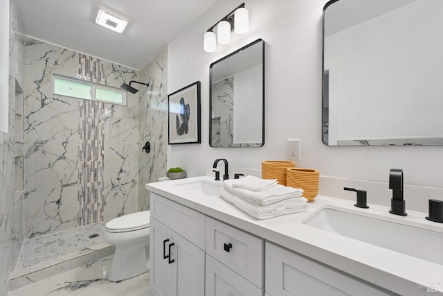 full bathroom featuring marble finish floor, a marble finish shower, a sink, and toilet