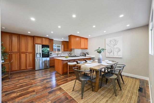 dining area with dark wood-style floors, visible vents, baseboards, and recessed lighting