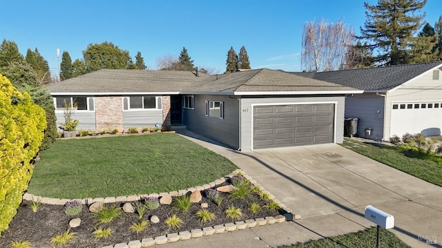 ranch-style house featuring a front yard, concrete driveway, and an attached garage