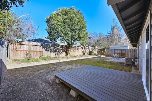 view of yard with a patio area, a fenced backyard, and central air condition unit