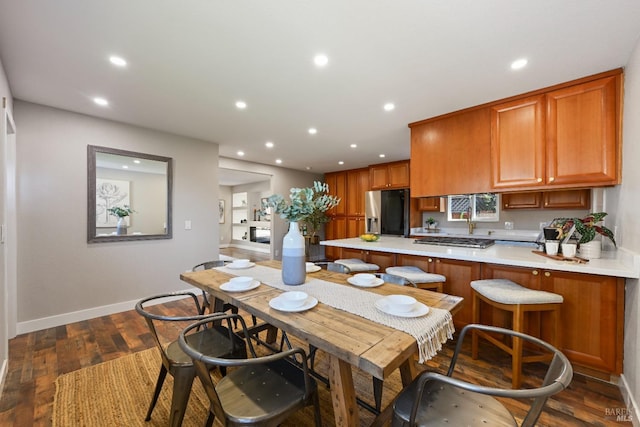 dining space featuring baseboards, dark wood finished floors, and recessed lighting