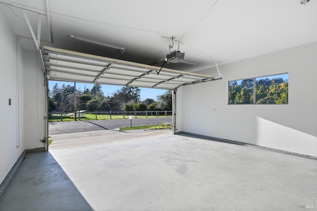 garage with a garage door opener and baseboards